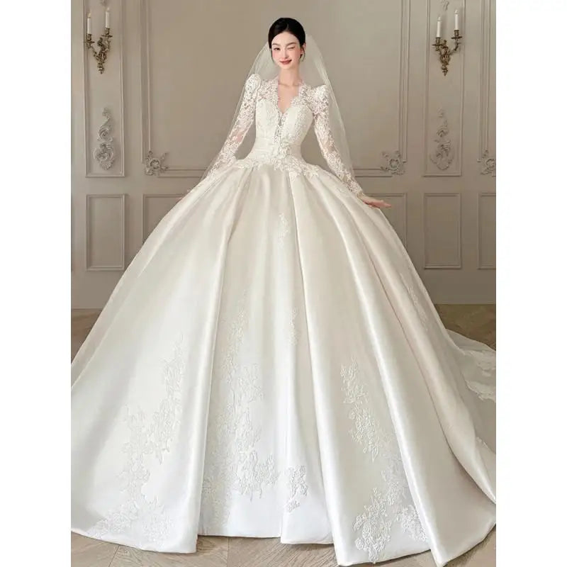 Robe de mariée satinée en dentelle à col V - CLEVI Paris